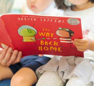 2 students reading a picture book