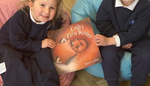 girls holding a book