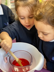 Nursery children stir jelly