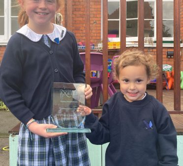 2 students holding our new award
